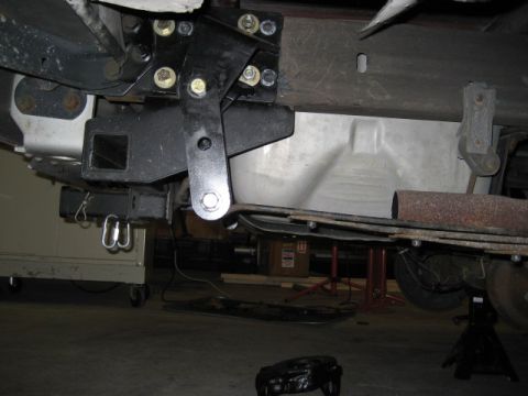 1996 Ford Bronco - Close-up of a trailer hitch and rear suspension components on a vehicle.