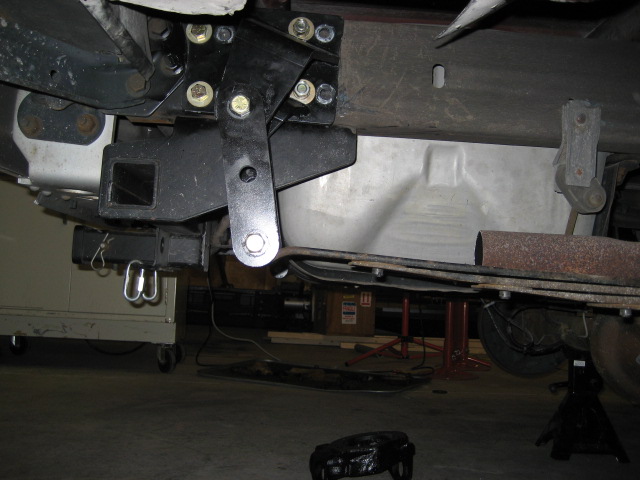 Trailer hitch receiver and leaf spring assembly on a vehicle frame