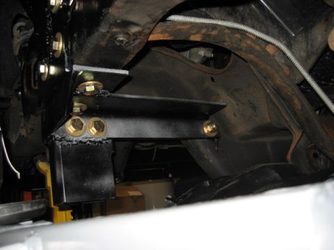 1996 Ford Bronco - Close-up view of aftermarket suspension components attached to a vehicle's frame.