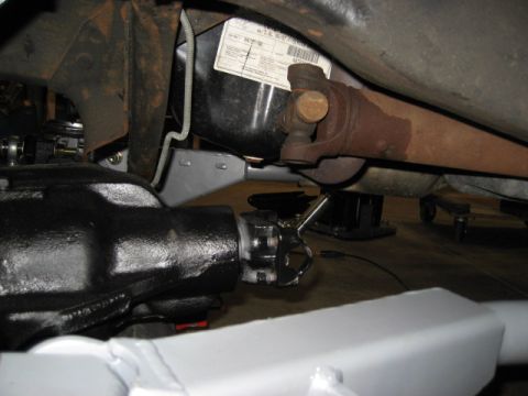 1996 Ford Bronco - Close-up of the rear axle and driveshaft assembly on a 1996 Ford Bronco, showing a date sticker on the fuel tank.