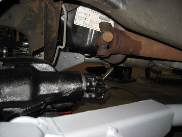 Underbody view of a 1996 Ford Bronco rear axle and driveshaft with a visible date sticker