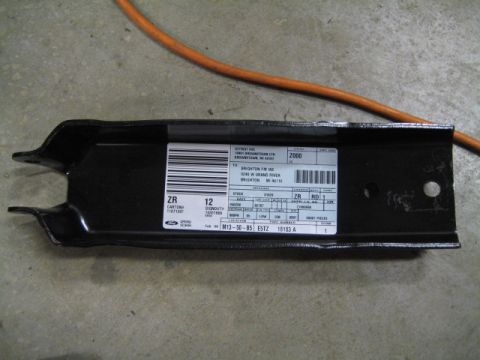1996 Ford Bronco - A metal bracket with a label indicating it is a part for a 2000 model year vehicle.