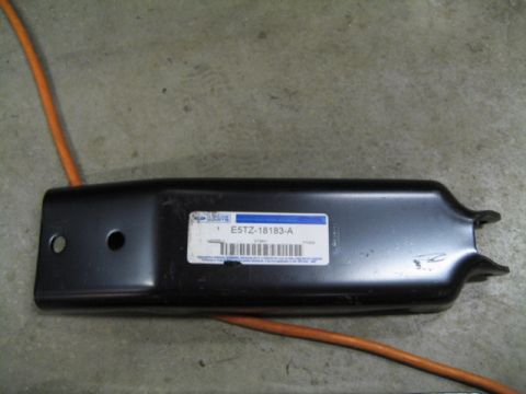 1996 Ford Bronco - A black metal part, likely a bracket or support, is shown with a white Ford parts label attached.