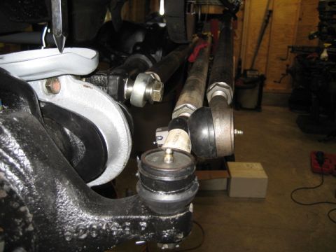 1996 Ford Bronco - The image shows a close-up view of a vehicle's steering linkage system, including tie rods and ball joints.
