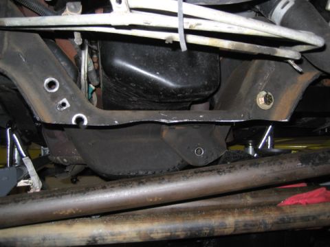 1996 Ford Bronco - Close-up view of the undercarriage, showing suspension components and the oil pan.