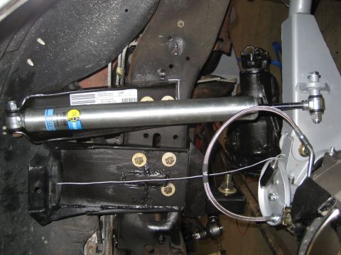 1996 Ford Bronco - This image shows a close-up view of a vehicle's suspension system, highlighting a shock absorber and associated hardware.