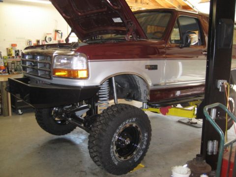1996 Ford Bronco - This 1996 Ford Bronco is on a lift, with its hood open, revealing custom modifications.