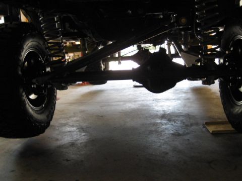 1996 Ford Bronco - This photo shows the undercarriage of a vehicle, focusing on the suspension and drivetrain components.