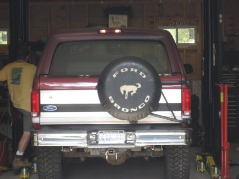 1996 Ford Bronco - Rear view of a 1996 Ford Bronco parked inside a garage with a spare tire mounted.