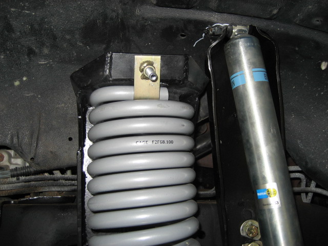Gray coil spring with part number CAGE F2FGB.100 and a Bilstein shock absorber