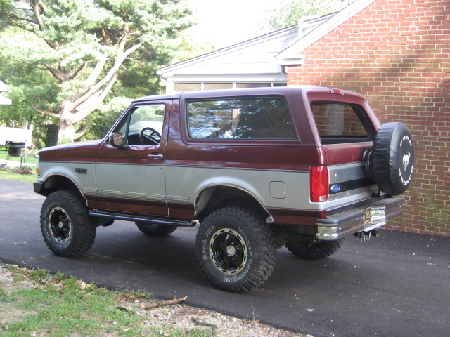 Maroon and silver 1996 Ford Bronco parked on asphalt