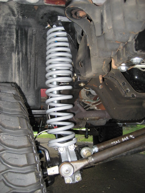 1996 Ford Bronco - Vehicle suspension components, including a coil spring and track bar, are shown in detail.