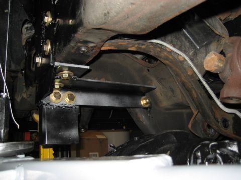 1996 Ford Bronco - Close-up view of aftermarket suspension components and hardware installed on a vehicle's undercarriage.