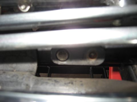 2004 Harley-Davidson Sportster Custom - Detail shot of motorcycle frame components, showing two circular indentations for bolts.