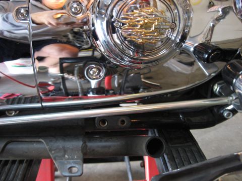 2004 Harley-Davidson Sportster Custom - Close-up of the chrome engine cover a flame design, indicative of a 2004 Harley-Davidson Sportster Custom.
