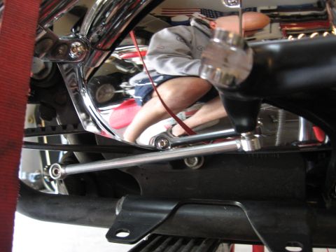 2004 Harley-Davidson Sportster Custom - Close-up view of motorcycle frame and engine components, with a reflection of a person in the chrome plating.