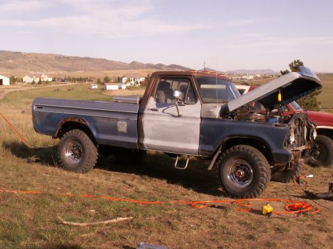 1977 Ford F-250 - This 1977 Ford F-250 pickup truck is parked outdoors with its hood up, revealing the engine compartment.