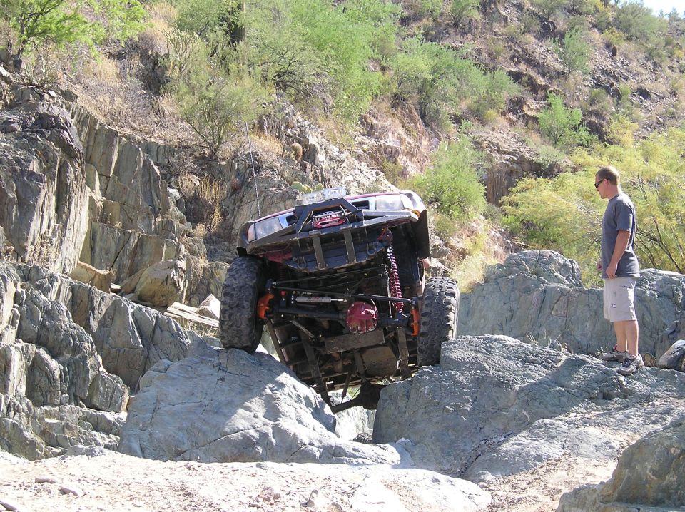 Off-road truck climbing rocks, front view