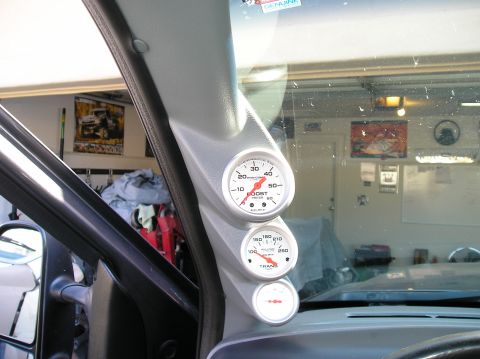 2001 Ford F-350 - A set of three gauges, including boost and transmission temperature, are installed on the A-pillar inside a vehicle.