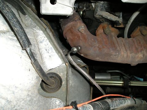 2001 Ford F-350 - Close-up view of an exhaust manifold and its attached oxygen sensor, likely from a vehicle's engine bay.