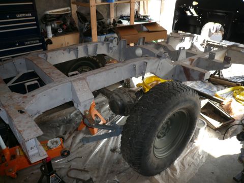 1974 Land Rover Land Rover - The chassis of a vehicle is elevated on jacks and stands, undergoing maintenance or restoration.
