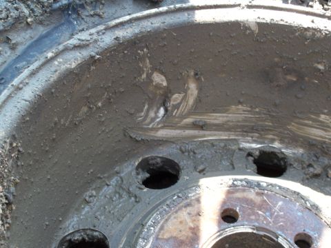 1996 Ford Bronco - This close-up shows a heavily mud-covered wheel and tire, obscuring any identifying details.