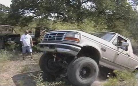 1996 Ford Bronco - A white Ford F-Series truck is shown at an angle with a man standing behind it.