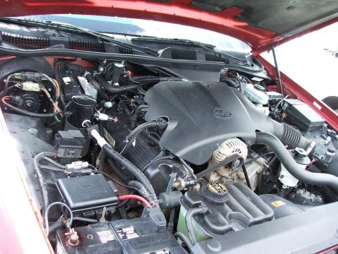1985 Ford Crown Victoria LTD - The engine bay of a vehicle, the Ford logo on the engine cover and various mechanical components.