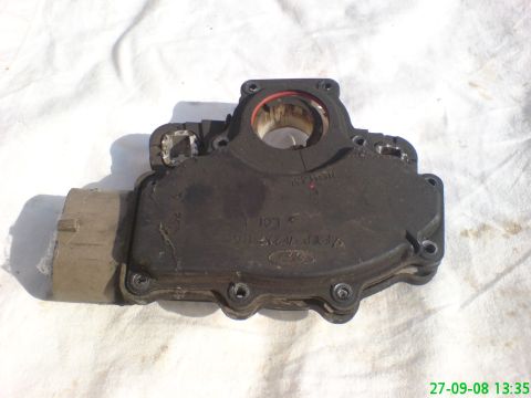 1994 Ford Thunderbird - This automatic transmission range sensor, marked with a Ford logo and part number F77P-7C267-AA, is shown against a white cloth background.