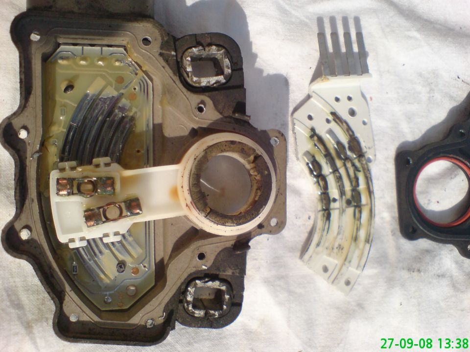 Disassembled transmission range sensor with electrical contacts and wiring