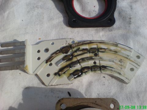 1994 Ford Thunderbird - A close-up view of a damaged automotive part with visible wear and tear.