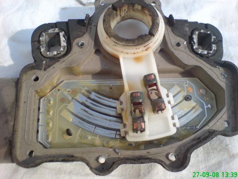 1994 Ford Thunderbird - Close-up view of an automotive component, likely a sensor or control module, showing its internal circuitry and electrical contacts.