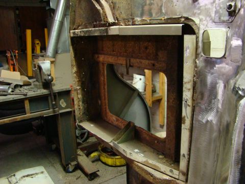 1948 Jeep Wrangler - This image shows a heavily rusted section of a vehicle's body, likely undergoing repair or restoration, with a large opening revealing inte…