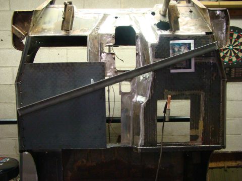 1948 Jeep Wrangler - This vehicle body is undergoing repairs or modifications, with exposed metal and added plating visible.