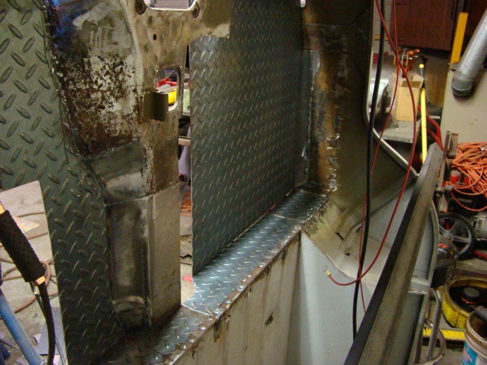 Diamond plate metal installed on a vehicle's interior floor and lower wall during body repair
