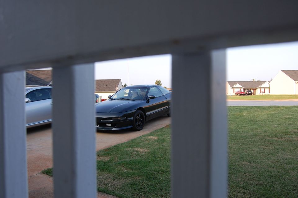 1996 Ford Probe parked in driveway next to a silver car
