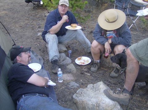 1986 Ford Bronco - Campers enjoy a meal outdoors with their dog.