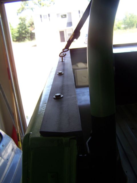 1975 Chevrolet Blazer - Close-up of a truck bed rail showing a bolted metal bracket and tie-down anchor point.