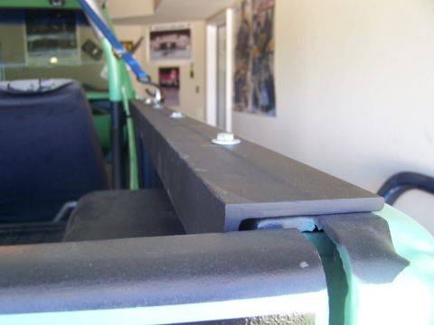 1975 Chevrolet Blazer - A custom rail is bolted onto the edge of a vehicle bed, with a blue strap visible overhead.