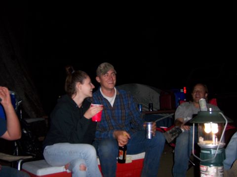 1991 Ford Bronco - A group of friends enjoy a night out camping, gathered around a lantern.