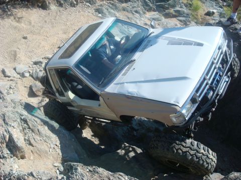 1986 Toyota Hilux - This pickup truck is off-roading on a steep, rocky terrain.