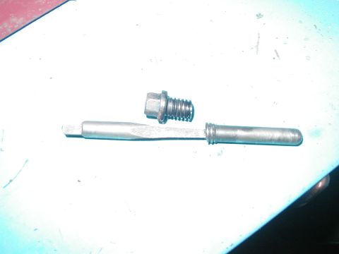1989 Ford Bronco - The offending bolt: the head that easily comes out, and the broken end, with the bolt extractor still lodged in.