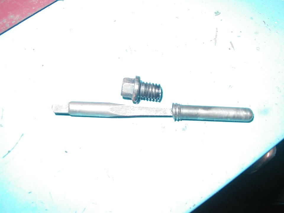 The offending bolt: the head that easily comes out, and the broken end, with the bolt extractor still lodged in.