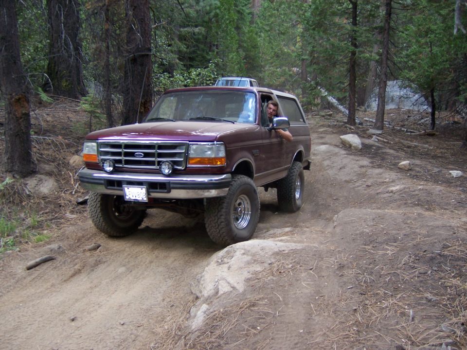 Maroon 1992 Ford Bronco on a dirt trail