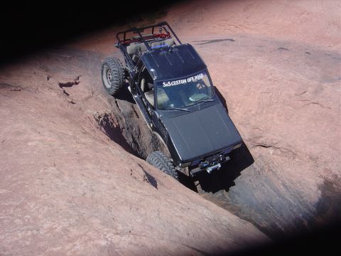 1986 Ford Bronco II - This modified SUV navigates a challenging off-road trail, its capabilities.