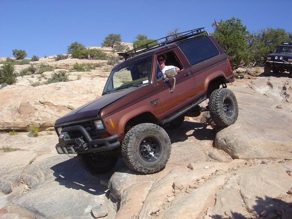 Brown 1986 Ford Bronco II climbing rocky terrain