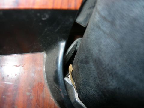 1984 Ford Bronco - Close-up view of interior car trim and upholstery, showing a gap with debris.