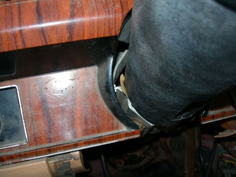 1984 Ford Bronco - Close-up view of the woodgrain trim on the dashboard and the steering column of a vehicle.