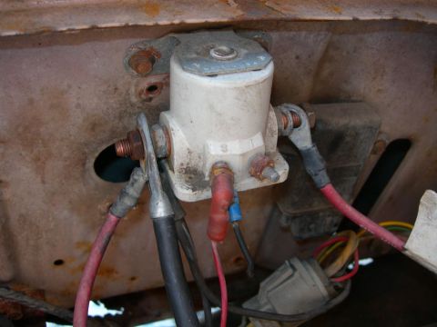1984 Ford Bronco - Close-up of a vehicle's starter solenoid and associated wiring, showing signs of age and corrosion.