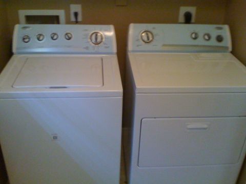 1966 Ford Bronco - A washing machine and dryer are shown together, with electrical outlets visible above them.